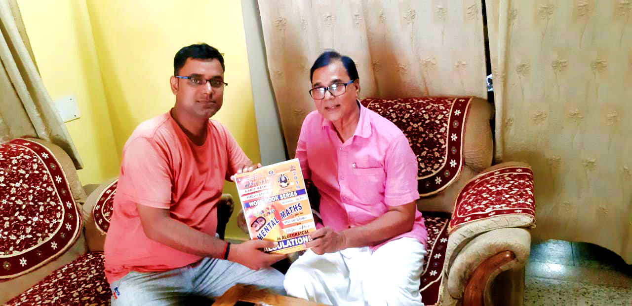Dr.Madhepuri receiving a book 